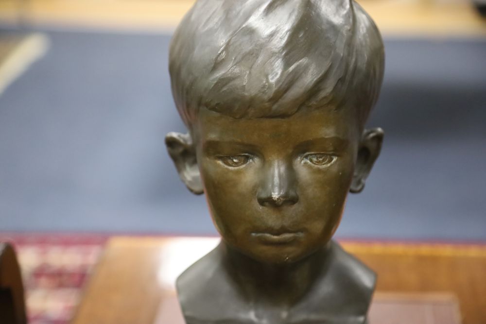 A bronze bust of a boy, signed R.Swann 1930, on marble base, height 38cm, some scuffing to the nose shows some white metal although we